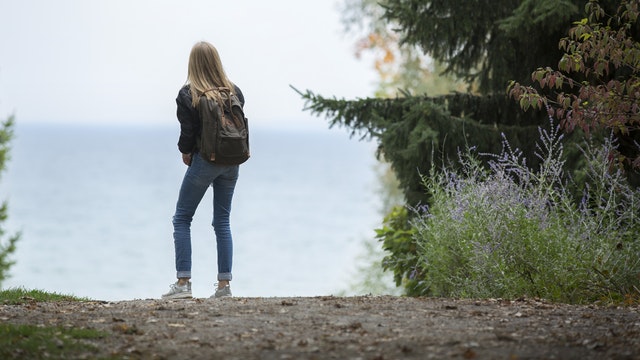 Woman looking out over lake